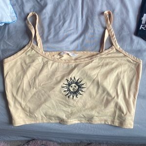 Yellow/ neutral yellow Romwe crop tank top with sun design.